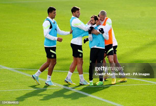 Manchester City's Bernardo Silva, Erling Haaland and Ruben Dias during a training session at the City Football Academy, Manchester. Picture date:...