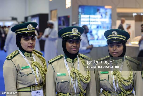 Emirati policewomen pose for a picture during the opening of the International Exhibtion For National Security and Resilience in the Emirati capital...