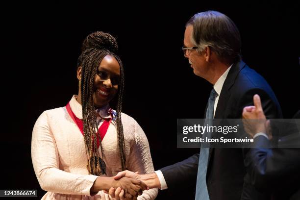 Writer Chimamanda Ngozi Adichie shakes hands with Glenn H. Hutchins after receiving her medal during the Harvard University Hutchins Center Honors...