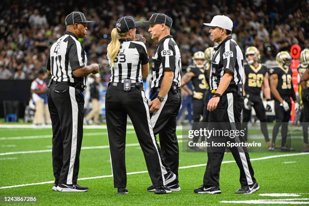 Side judge Boris Cheek , down judge Sarah Thomas , line judge Daniel Gallagher , and referee Brad Allen chat during a timeout during the football...