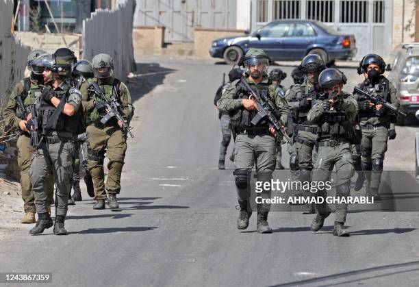 Israeli security forces conduct a search the Palestinian Shuafat refugee camp in Israeli-annexed east Jerusalem, on October 10, 2022. - Israeli...
