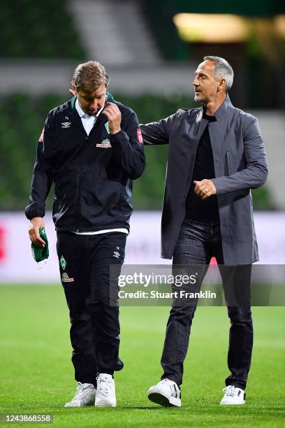 Florian Kohfeldt, Head Coach of SV Werder Bremen is consoled by Adolf Hutter, Head Coach of Eintracht Frankfurt after the Bundesliga match between SV...
