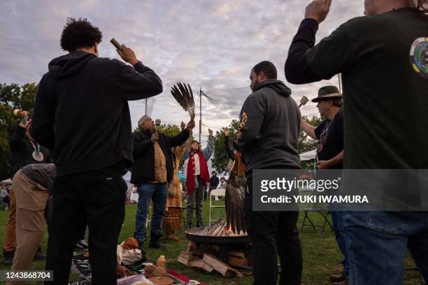 People participate an Indigenous Peoples' Day sunrise ceremony on Randall's Island in New York City on October 10, 2022. - The federal holiday to...