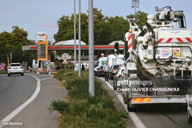 Vehicles queue for petrol at a TotalEnergies station in Bron, near Lyon on October 10, 2022 as filling stations across France are low on petrol as a...