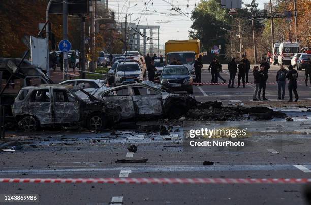 Burned cars and covered body is seen at the site of missile strike downtown Kyiv, Ukraine, October 10, 2022. Russia attacks multiple cities of...