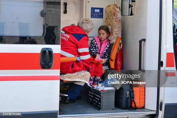 An ambulance worker attends to a girl after a Russian shelling in Kyiv. After several months of relative calm, multiple explosions rocked Kyiv early...