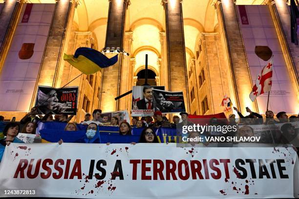 Demonstrators rally to condemn Russian strikes on Ukraine during an event organised by Ukrainian refugees and activists, in Tbilisi on October 10,...