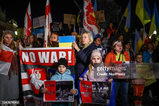 Ukrainian citizens and supporters attend a demonstration of solidarity with Ukraine at the Main Square, after latest Russian missiles targeted...