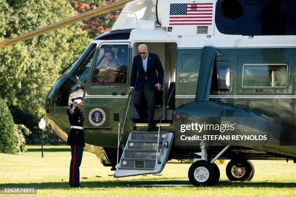 President Joe Biden disembarks Marine One on the South Lawn of the White House in Washington, DC, on October 10, 2022. - The President returned to...