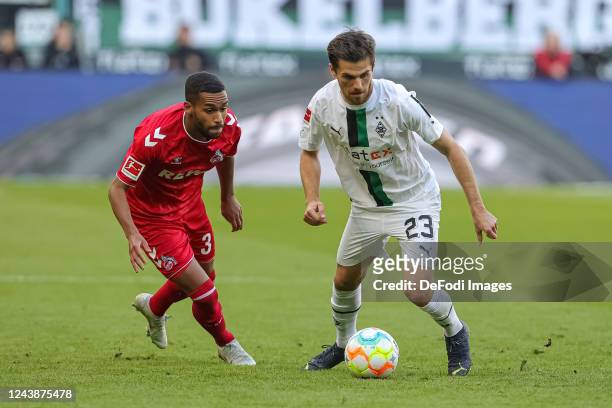 Linton Maina of 1. FC Koeln and Jonas Hofmann of Borussia Moenchengladbach battle for the ball during the Bundesliga match between Borussia...
