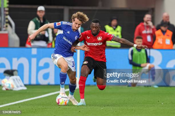 Alex Kral of FC Schalke 04 and Callum Hudson-Odoi of Bayer 04 Leverkusen battle for the ball during the Bundesliga match between Bayer 04 Leverkusen...