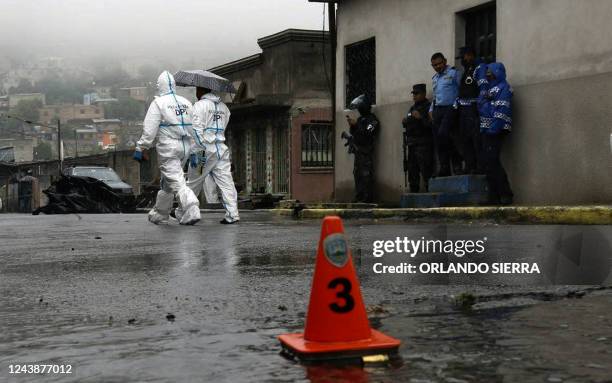 Members of the National Police and forensic experts work at the crime scene where journalist Edwin Josue Andino was murdered by armed men in Military...