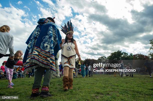 Different tribes and members of the public take part in dancing with the Wampanoag tribe at Indigenous Peoples Day in Newton, Massachusetts on...