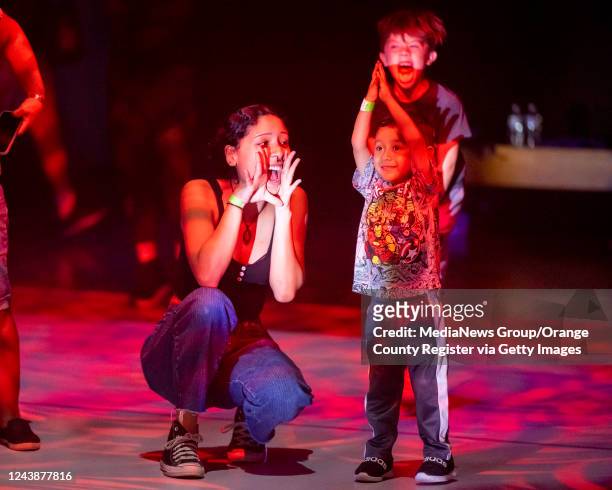 Jessica Flores, left, sings out with her nephew Isaac Lopez, 4 during the Pumpkin Palooza Dance Party at the Discovery Cube in Santa Ana on Thursday,...