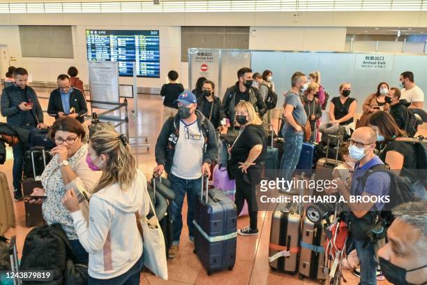 Group of tourists arrive at the international terminal of Tokyo's Haneda Airport on October 11 as Japan reopened to foreign travellers after...