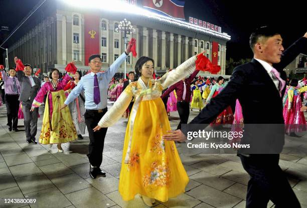 People dance on the night of Oct. 10 at Kim Il Sung Square in Pyongyang to celebrate the 77th anniversary of the founding of the ruling Workers'...