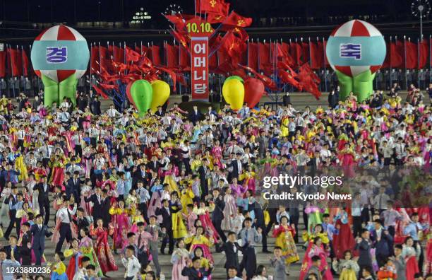 People gather on the night of Oct. 10 at Kim Il Sung Square in Pyongyang to celebrate the 77th anniversary of the founding of the ruling Workers'...