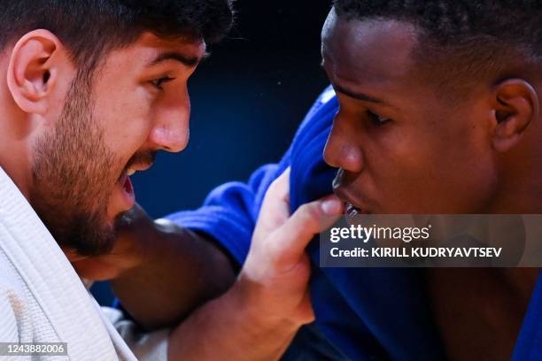 France's Kenny Liveze and Turkey's Mert Sismanlar compete in their men's under 100 kg category elimination round bout during the 2022 World Judo...