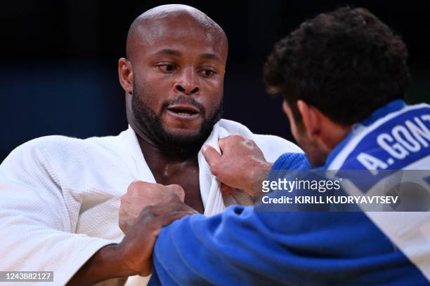 Portugal's Jorge Fonseca and Romania's Asley Gonzalez compete in their men's under 100 kg category elimination round bout during the 2022 World Judo...
