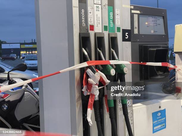Lanes are placed on gasoline pumps to show they are out of order at a gas station as fuel shortage continues in Goussainville, France on October 10,...