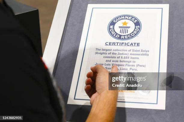 Jorge Vasquez shows a Guinness World Record certificate of the Saint Seiya Museum located at the Plaza Norte Shopping Center in Lima, Peru on...