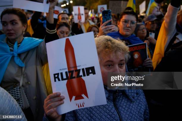 Woman holds a sign with a grahpic of a missile rocket during a rally in front of the Russian Embassy in Warsaw, Poland on 10 October, 2022. Several...