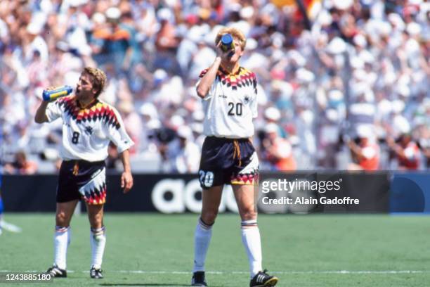 Thomas Hassler and Stefan Effenberg of Germany drink water during the FIFA World Cup match between Germany and South Korea, at Cotton Bowl, Dallas,...
