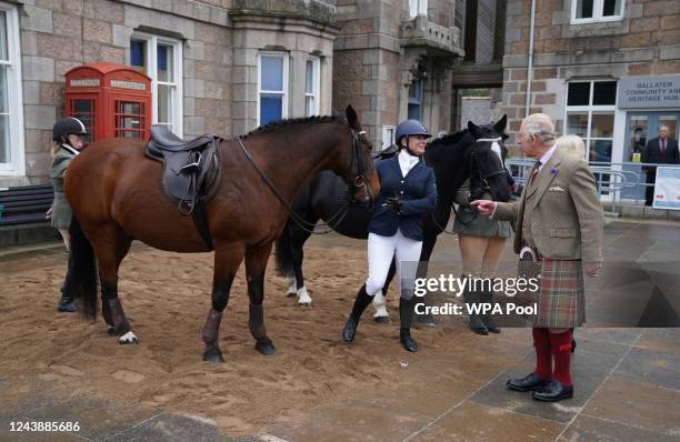 King Charles III feeds carrots to horses as he attends a reception to thank the community of Aberdeenshire for their organisation and support...