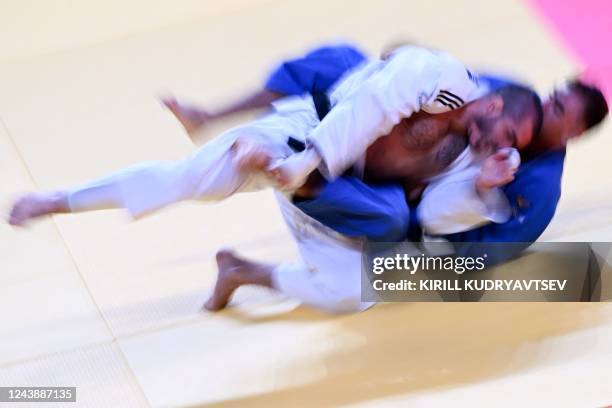 Belgium's Toma Nikiforov and Azerbaijan's Zelym Kotsoiev compete in their men's under 100 kg category bronze medal bout during the 2022 World Judo...