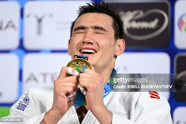 Gold medallist Uzbekistan's Muzaffarbek Turoboyev celebrates during the medal ceremony for the men's under 100 kg category during the 2022 World Judo...