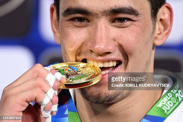 Gold medallist Uzbekistan's Muzaffarbek Turoboyev celebrates during the medal ceremony for the men's under 100 kg category during the 2022 World Judo...