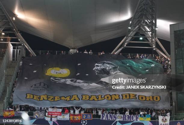 Real Madrid fans support the team with a banner for Real Madrid's French forward Karim Benzema during the UEFA Champions League group F football...