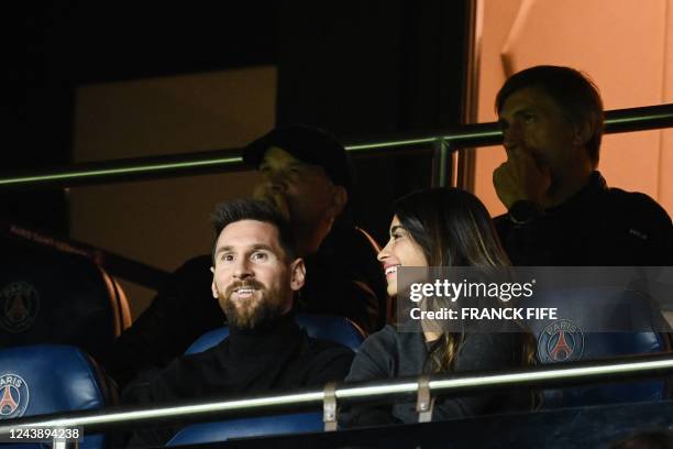 Paris Saint-Germain's Argentine forward Lionel Messi and his wife Antonella Roccuzzo watch the UEFA Champions League group H football match between...