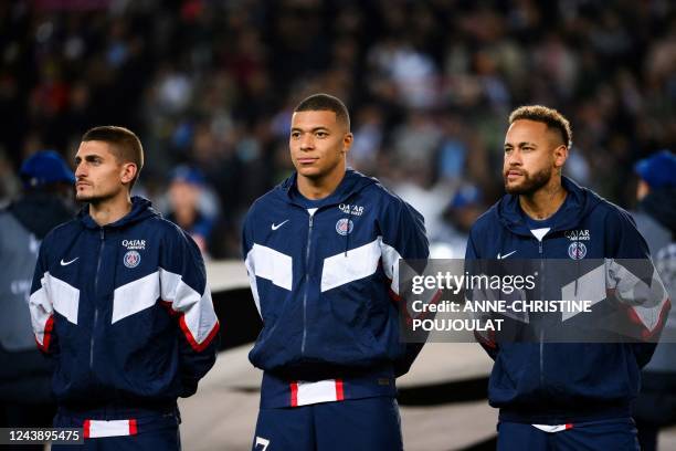 Paris Saint-Germain's Italian midfielder Marco Verratti, French forward Kylian Mbappe and Brazilian forward Neymar line up prior to the UEFA...