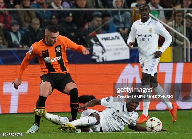 Real Madrid's French defender Aurelien Tchouameni and Shakhtar Donetsk's Ukrainian forward Oleksandr Zubkov vie for the ball during the UEFA...