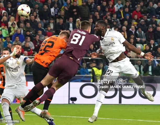 Real Madrid's German defender Antonio Rudiger scores the 1-1 goal Shakhtar Donetsk's Ukrainian goalkeeper Anatoliy Trubin and Shakhtar Donetsk's...