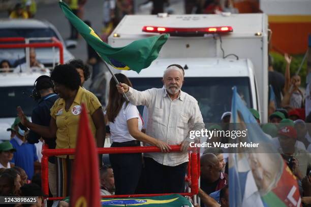 Former president of Brazil and candidate of Workers Party Luiz Inacio Lula Da Silva waves a Brazilian flag during a campaign rally ahead of...