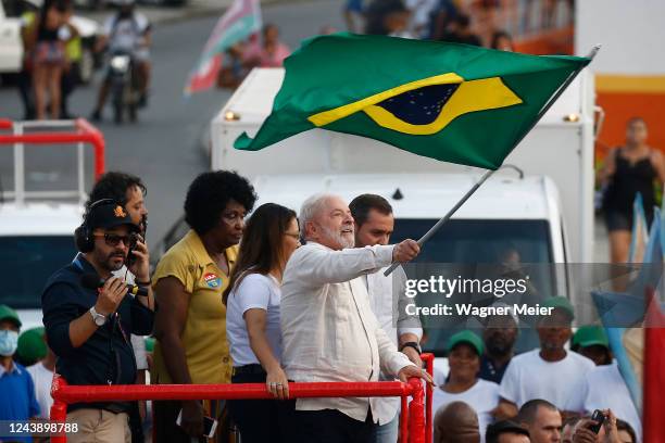 Former president of Brazil and candidate of Workers Party Luiz Inacio Lula Da Silva waves a Brazilian flag during a campaign rally ahead of...