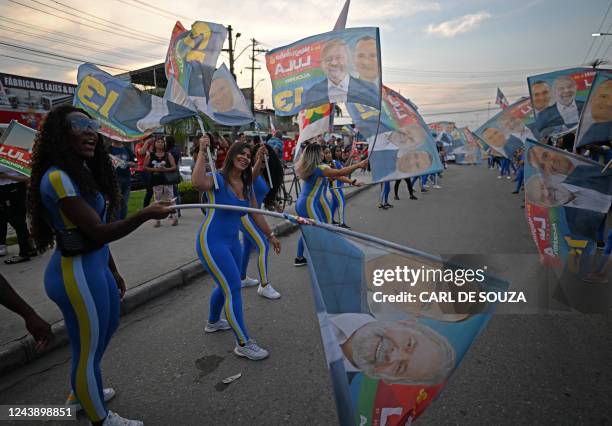 Supporters of Brazil's former president and presidential candidate for the leftist Workers Party , Luiz Inacio Lula da Silva wave flags during a...