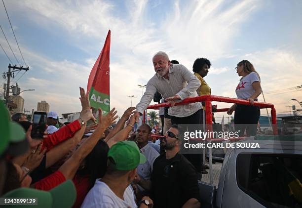 Brazil's former president and presidential candidate for the leftist Workers Party , Luiz Inacio Lula da Silva, greets supporter during a campaign...