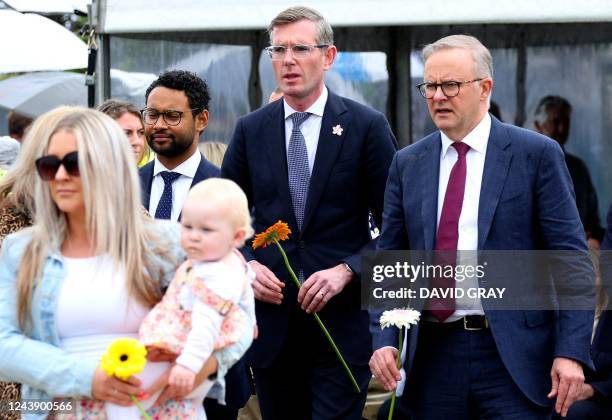 Australia's Prime Minister Anthony Albanese and New South Wales premier Dominic Perrottet proceed to lay flowers at the end of a commemoration...