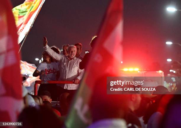 Brazil's former president and presidential candidate for the leftist Workers Party , Luiz Inacio Lula da Silva, waves at supporters during a campaign...