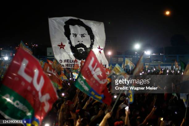 Supporters of Candidate of Workers Party Luiz Inacio Lula Da Silva wave flags during a campaign rally ahead of presidential run-off at Belford Roxo...
