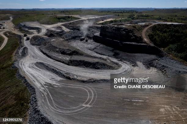 An aerial picture taken on September 29 shows trucks driving at a coal mine operated by Blackhawk Mining and Pine Branch Mining in Lost Creek,...
