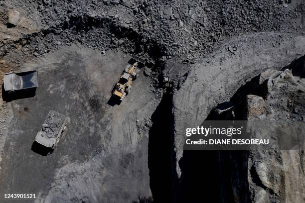 An aerial picture taken on September 29 shows trucks driving at a coal mine operated by Blackhawk Mining and Pine Branch Mining in Lost Creek,...