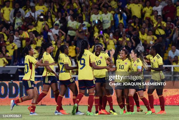 Colombia's Leicy Santos celebrates with teammates after scoring against Paraguay during a women's friendly football match at the Pascual Guerrero...