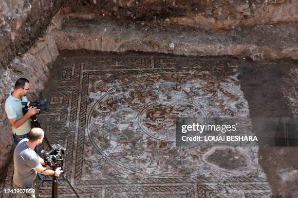 This picture taken on October 12, 2022 shows a view of a mosaic floor dating to the Roman era being excavated in the city of al-Rastan in Syria's...