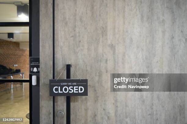 closed sign hung on wooden door - closing stock pictures, royalty-free photos & images