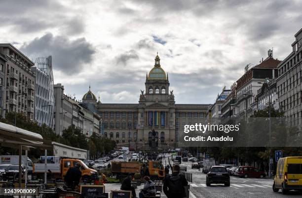 People and cars are seen around historic buildings in the capital of Czech Republic, Prague on October 5, 2022. Prague, the capital of Czech...