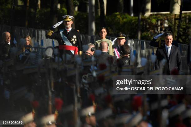King Felipe VI of Spain , Queen Letizia of Spain and Spain's Prime Minister Pedro Sanchez attend the Spanish National Day military parade in Madrid...